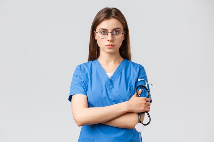 healthcare-workers-medicine-insurance-covid-19-pandemic-concept-serious-determined-professional-female-nurse-doctor-blue-scrubs-holding-stethoscope-wear-glasses-loo