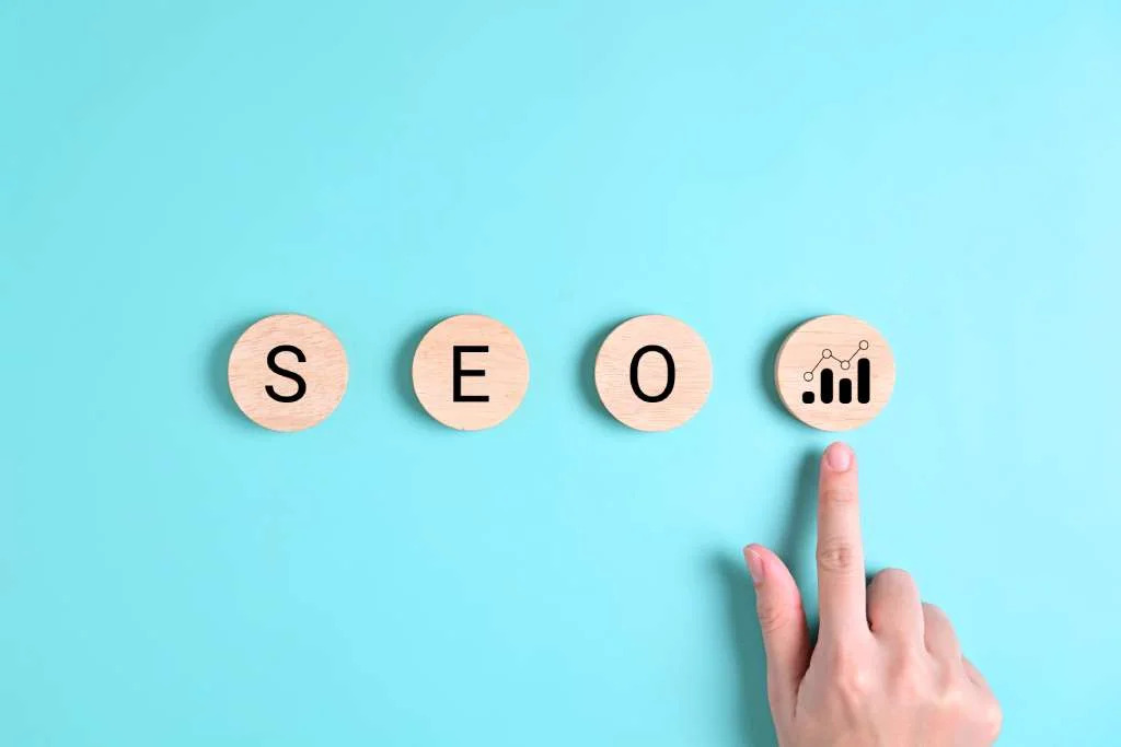 seo-word-blocks-on-blue-background-with-finger