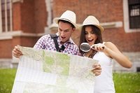 shocked-couple-looking-map-through-magnifying-glass