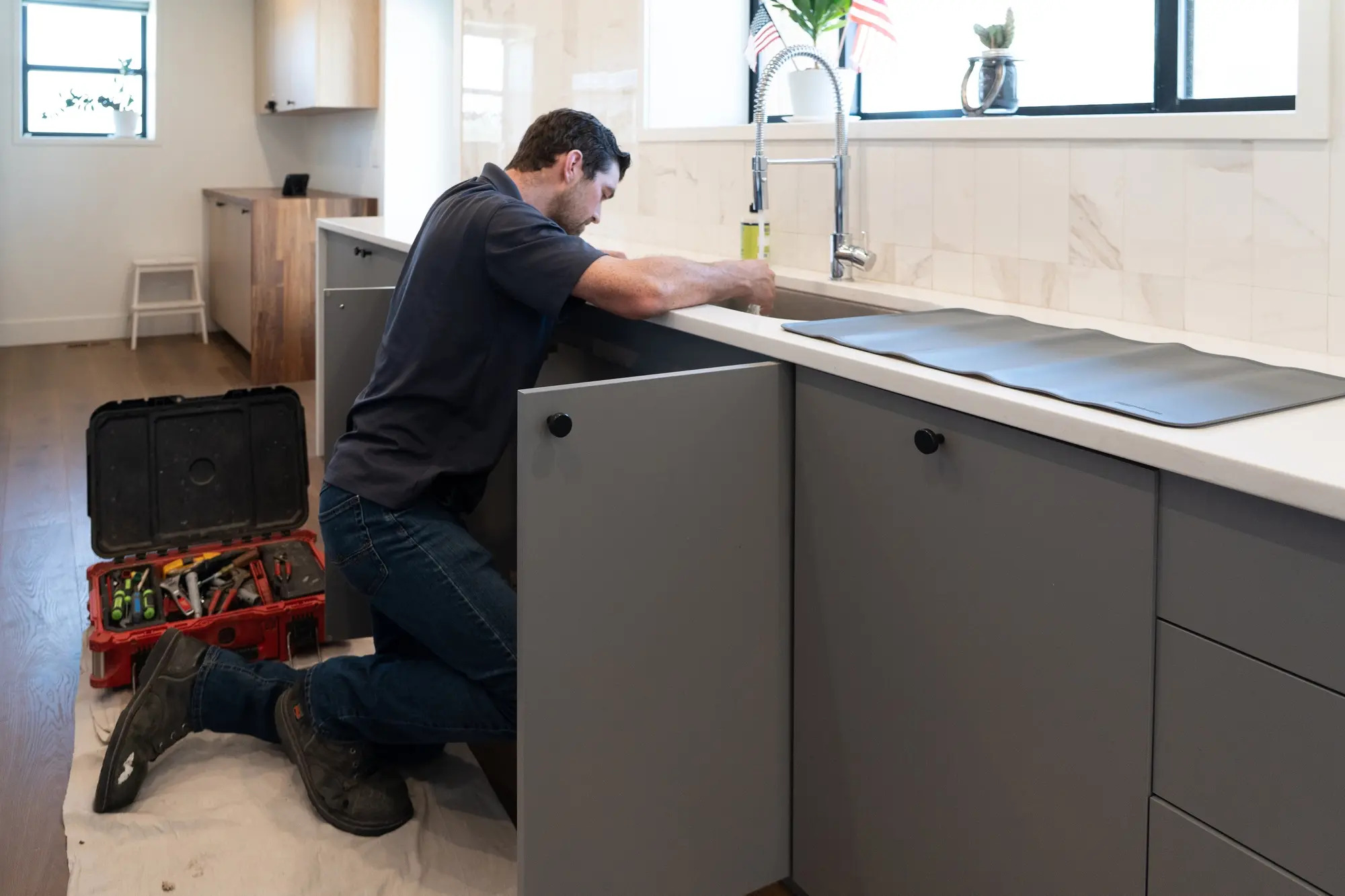 plumber-repairing-kitchen-sink